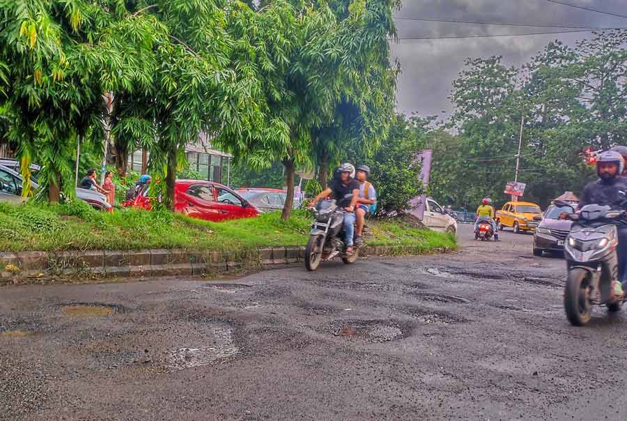 The peeled off asphalt of the road at the EM Bypass and Hyatt Regency crossing resembled lunar craters on Tuesday