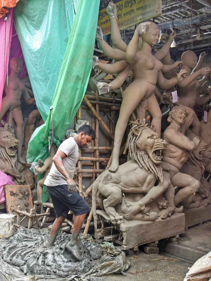 An artisan busy preparing the clay to be used in idol-making at Kumartuli 