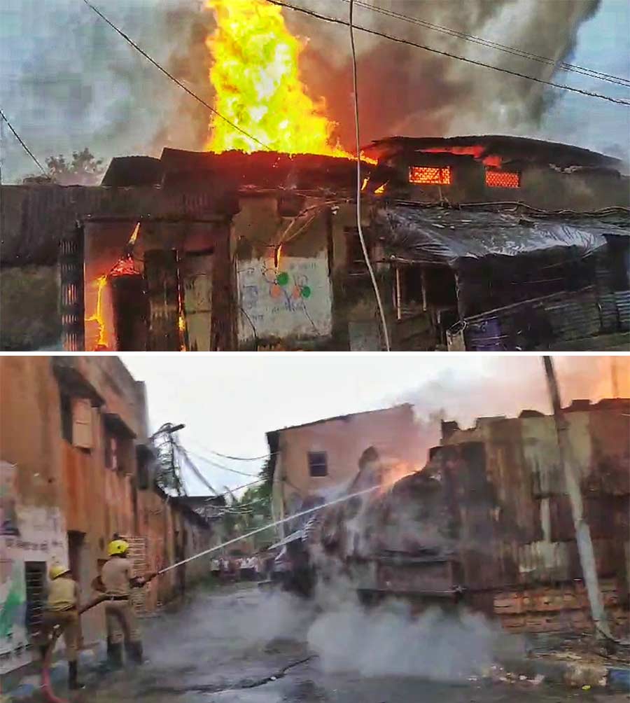 Firefighters use jets of water to douse a blaze in a wood godown at Canal Circular Road on Tuesday morning