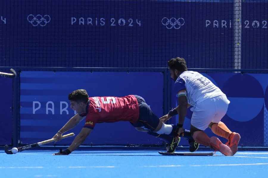 Spain's Jordi Bonastre, left, and India's Harmanpreet Singh fights for the ball 