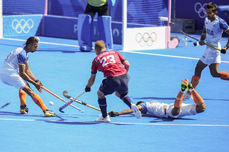 Hardik Singh (8) and Spain's Eduard de Ignacio-Simo (23) vie for the ball