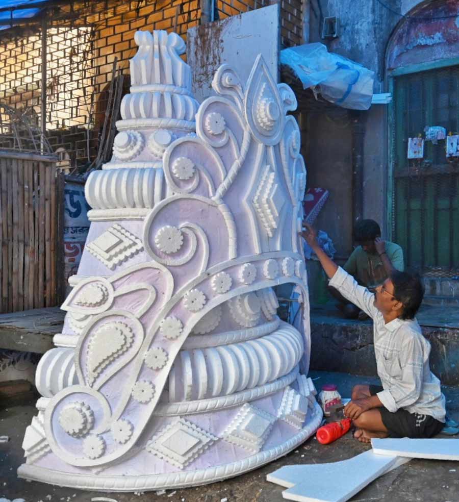 An artisan carves a big crown from thermocol at Dompara off Chittaranjan Avenue on Thursday for the ensuing wedding season  