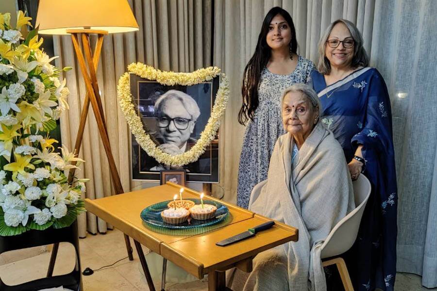 Shuli and Shanta Ghosh with Bharati Dutt beside a portrait of Sadhan Dutt