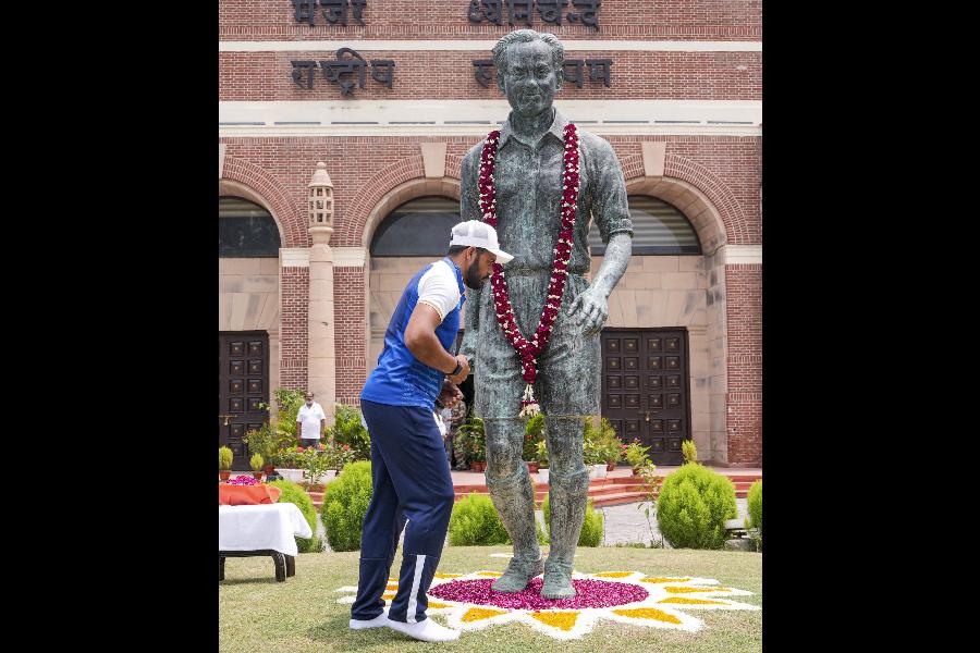 India captain Harmanpreet Singh pays tribute before the statue of three-time Olympic hockey gold medallist Dhyan Chand at the Major Dhyan Chand National Stadium in New Delhi on Saturday.