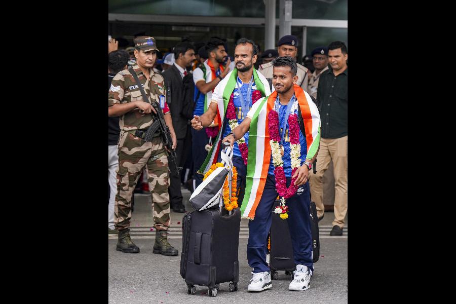Vivek Prasad and Lalit Upadhyay exit the airport.