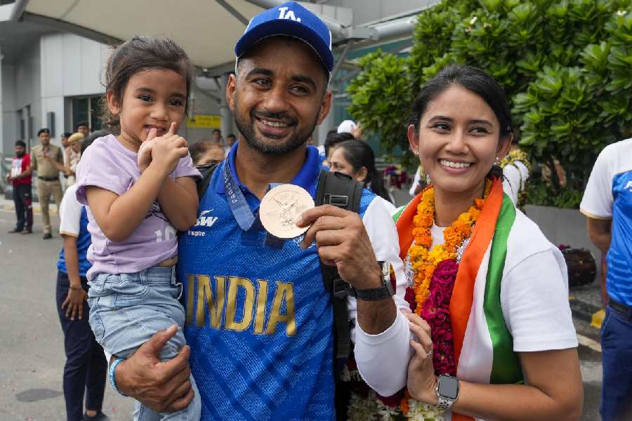 Hanpreet Singh with his family after arriving at the Indira Gandhi International Airport Lin New Delhi on Saturday.