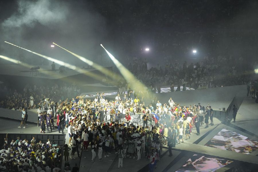 Teams gather around Phoenix as the band performs during the closing ceremony of the 2024 Summer Olympics at the Stade de France, in Paris, France, Sunday, Aug. 11, 2024