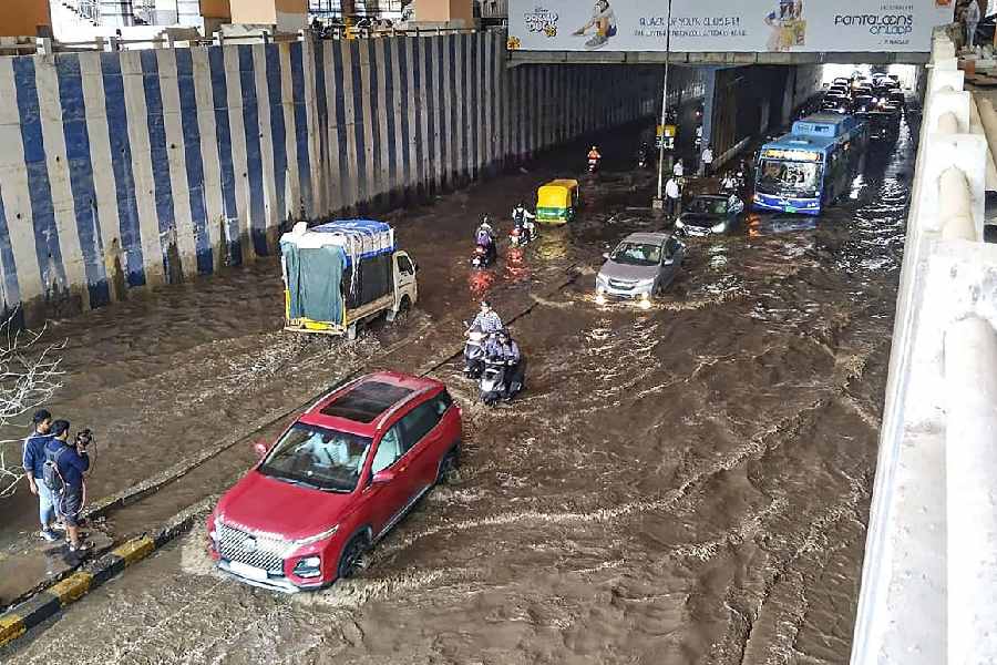 Vehicles pass through a waterlogged underpass near Jayadeva Hospital after heavy rainfall, in Bengaluru, Monday, Aug. 12, 2024