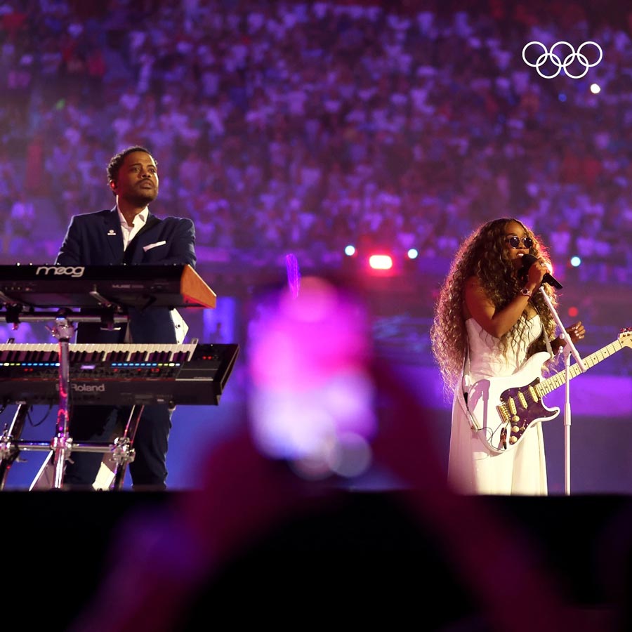Grammy-winning artiste (right) H.E.R. delivered a soulful rendition of the United States’ national anthem in Paris, facilitating the official passing of the baton 