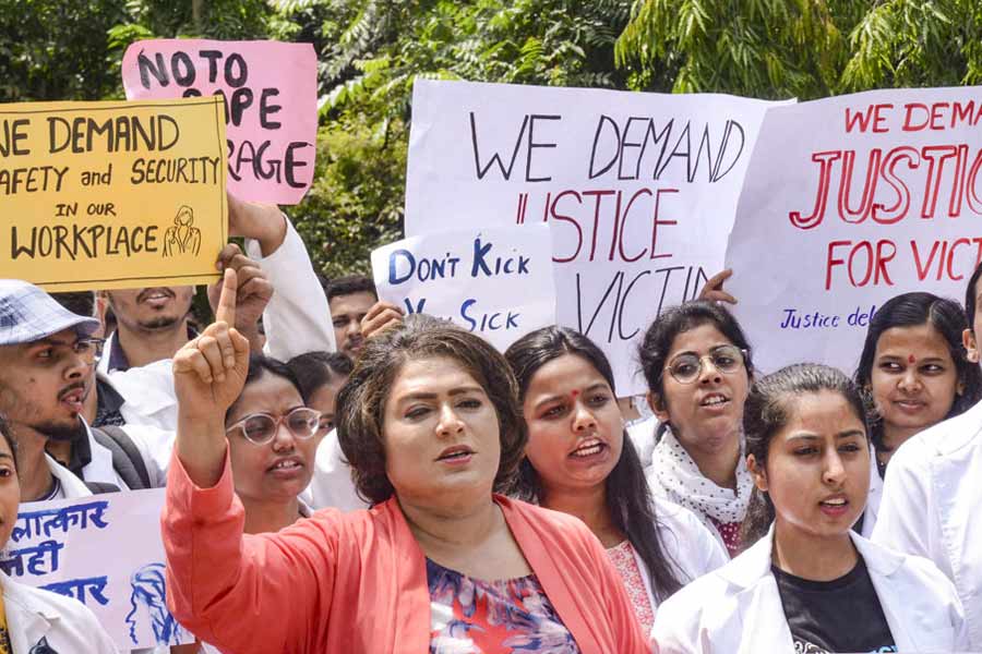 Junior doctors of Rajendra Institute of Medical Sciences (RIMS) stage a protest against the sexual assault and murder of a postgraduate trainee doctor in Calcutta, in Ranchi, Tuesday, Aug. 13, 2024