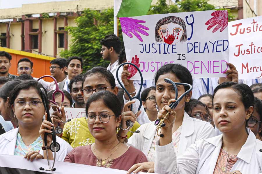 Junior doctors protest against the sexual assault and murder of a postgraduate trainee doctor in Calcutta, at Agartala Medical College, Tuesday, Aug. 13, 2024