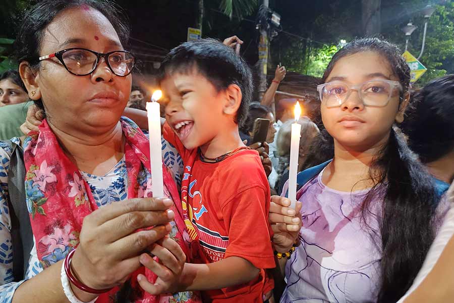 A middle aged woman with her two children at the College Street protest 