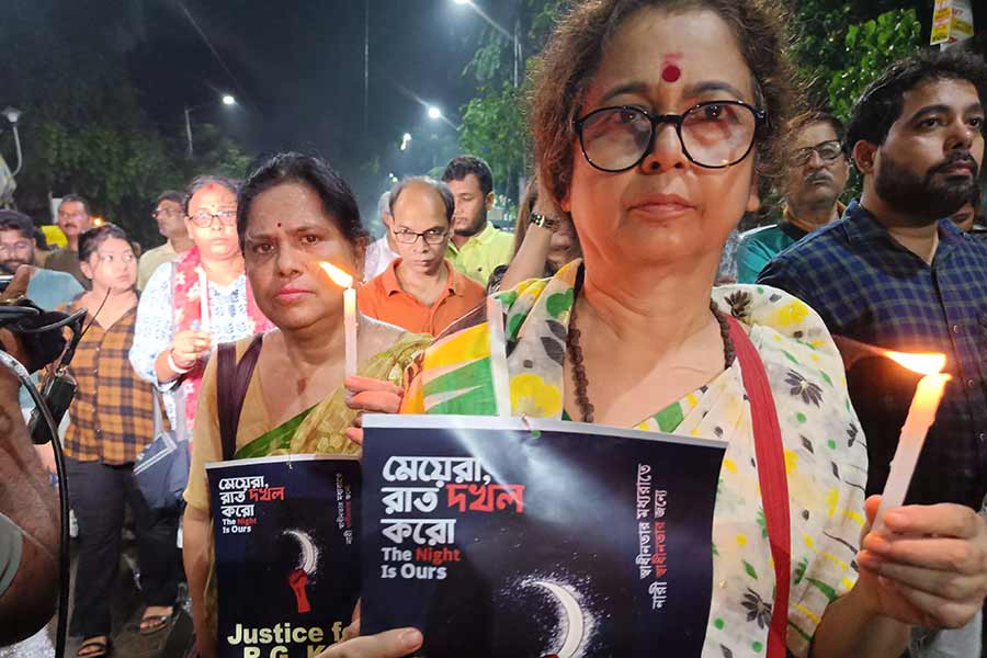 Middle aged woman walked together with students in the protest at College Street 