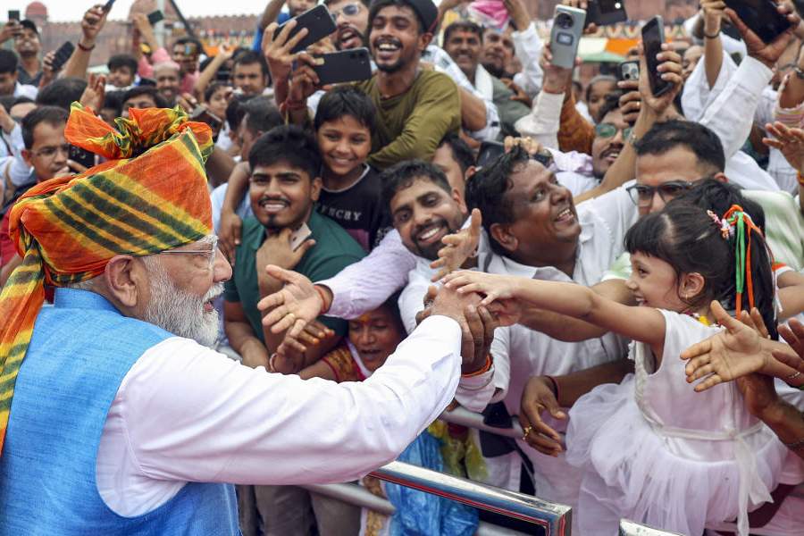 Prime Minister Narendra Modi greets people at the Red Fort on 78th Independence Day, in New Delhi, Thursday, Aug. 15, 2024.
