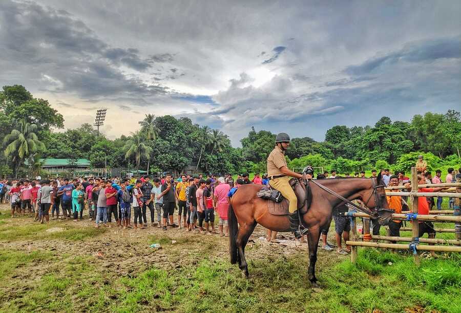 Hundreds of football fans queue up near the Mohun Bagan ground on Friday for tickets of the August 18 derby match  