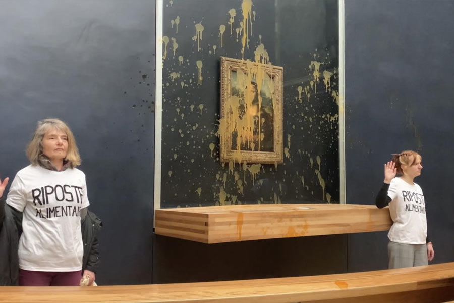 In this grab taken from video, activists gesture after throwing soup at the glass protecting the Mona Lisa, at the Louvre Museum, in Paris, Sunday. Jan. 28, 2024, shouting slogans advocating for a sustainable food system. It comes as French farmers have been protesting for days across the country against several issues, including low wages.