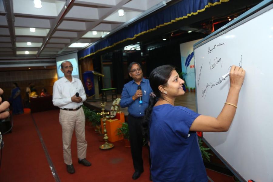 Parents write their signatures on a whiteboard as samples to be analysed