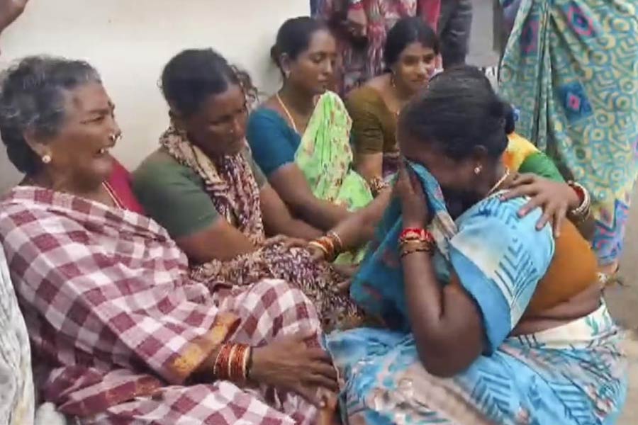 Relatives of victims of the Atchutapuram pharma unit fire mourn, in Anakapalli district, Thursday, Aug. 22, 2024.