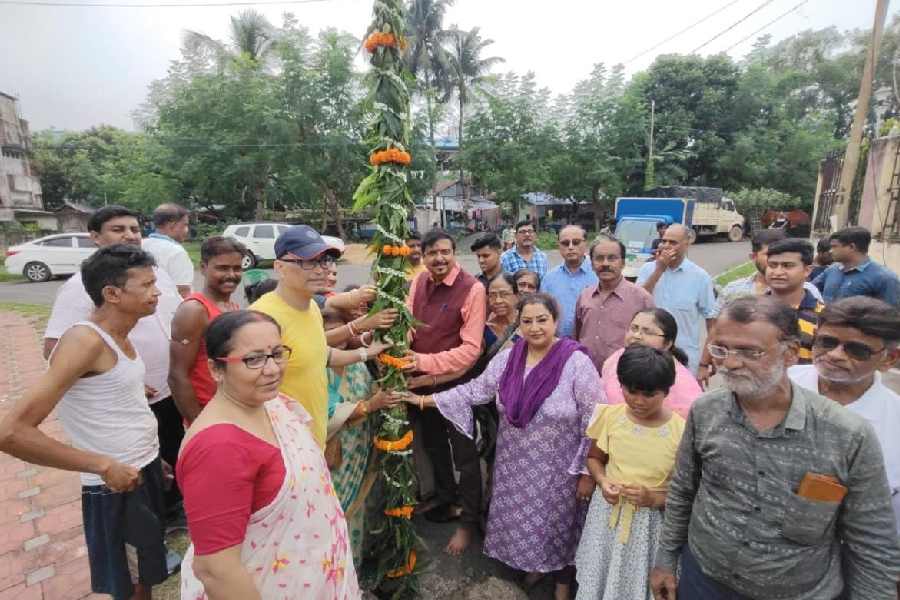 Sujit Bose holds the sacred pole with others at AA Block