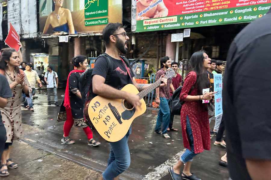 Songs are sung as the Presidency protest march winds its way through north Calcutta