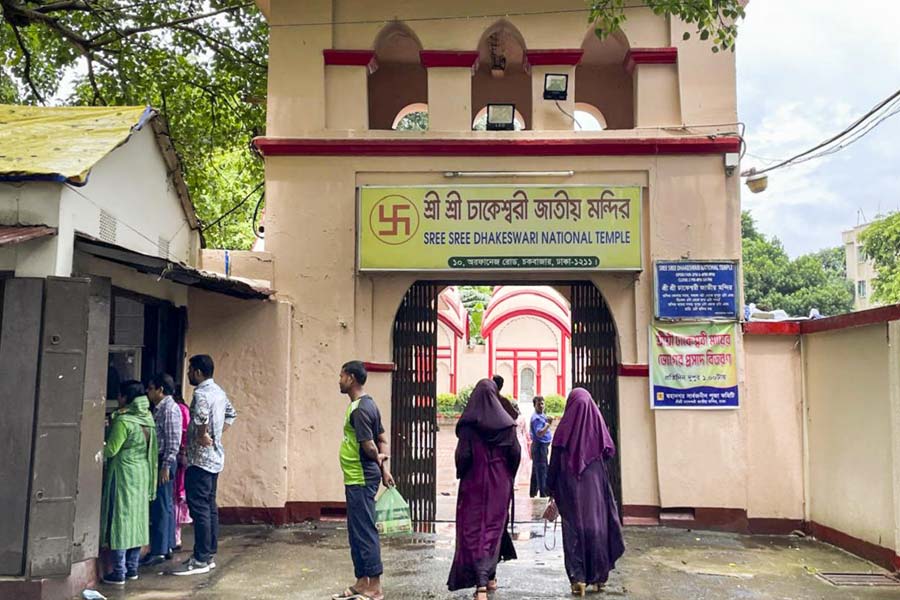 Visitors at the Dhakeshwari National Temple enter a gateway on the premises of the shrine at Old Dhaka area