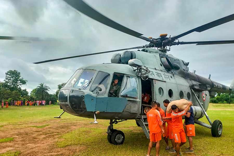 Food supplies being distributed through an Indian Air Force (IAF) helicopter at a flood-affected area of Tripura.