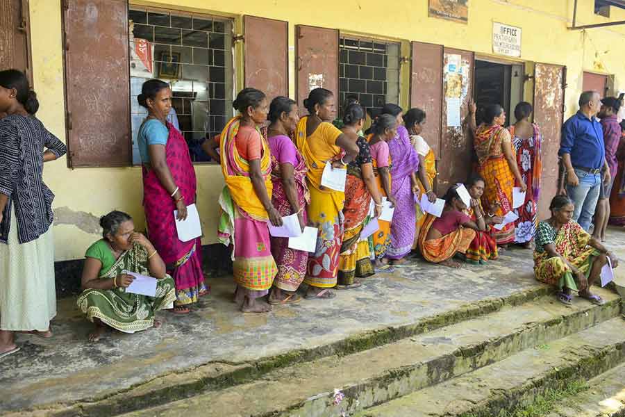 Flood-affected people stand in a queue during a health camp at a relief shelter after heavy monsoon, in Agartala, Saturday, Aug. 24, 2024.