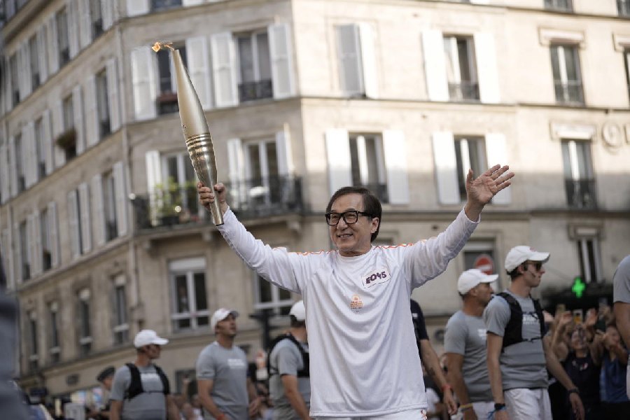 Jackie Chan carries the Paralympic torch Wednesday, Aug. 28, 2024 in Paris.