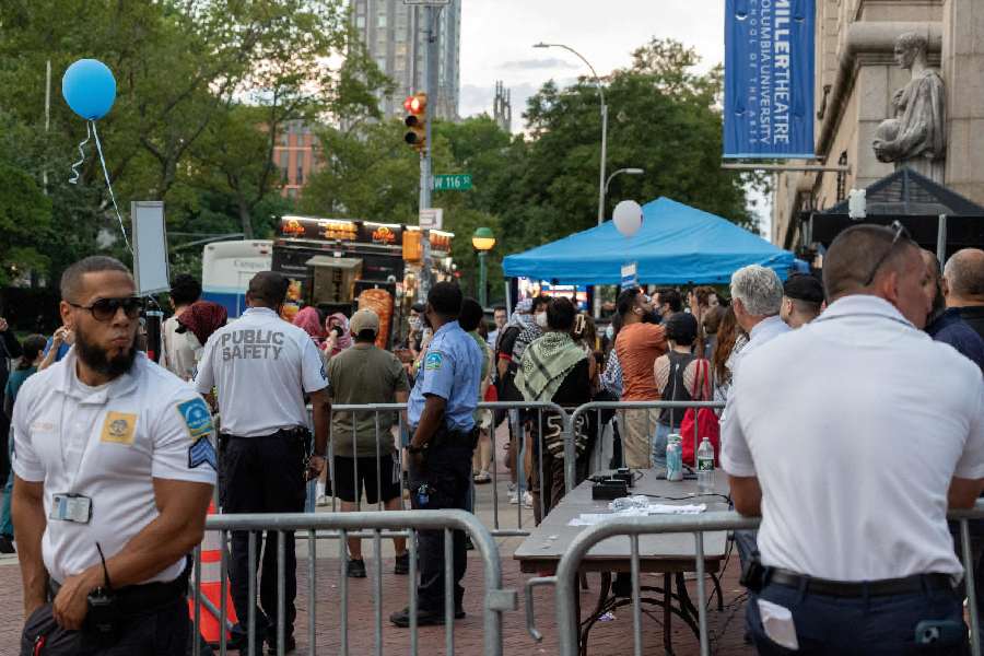 Public Safety officers monitor protesters gathered at a main entrance in front of Columbia University during convocation, amid the ongoing conflict in Gaza between Israel and Hamas, in New York City, U.S., August 25, 2024