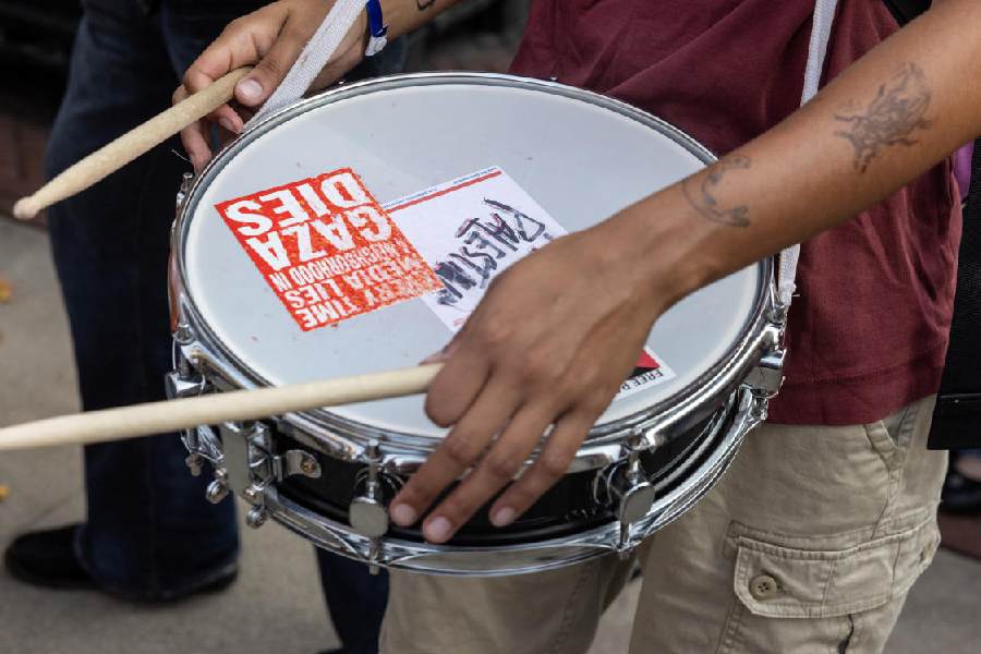 A demonstrator carries a snare drum as protesters gather in front of Columbia University during convocation, at a main gated entrance of Columbia University, amid the ongoing conflict in Gaza between Israel and Hamas, in New York City, U.S., August 25, 2024