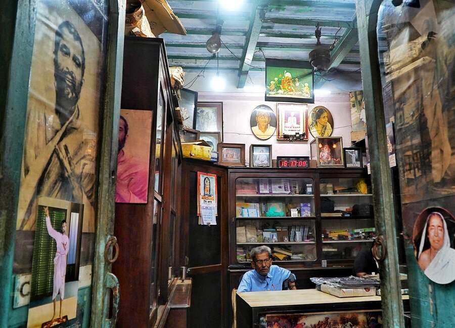 The age-old interiors of the shop take you back in time — teak and mahogany furniture and wood-glass showcases, high ceiling, wooden beams, old ceiling fan and lampshades among other things.  