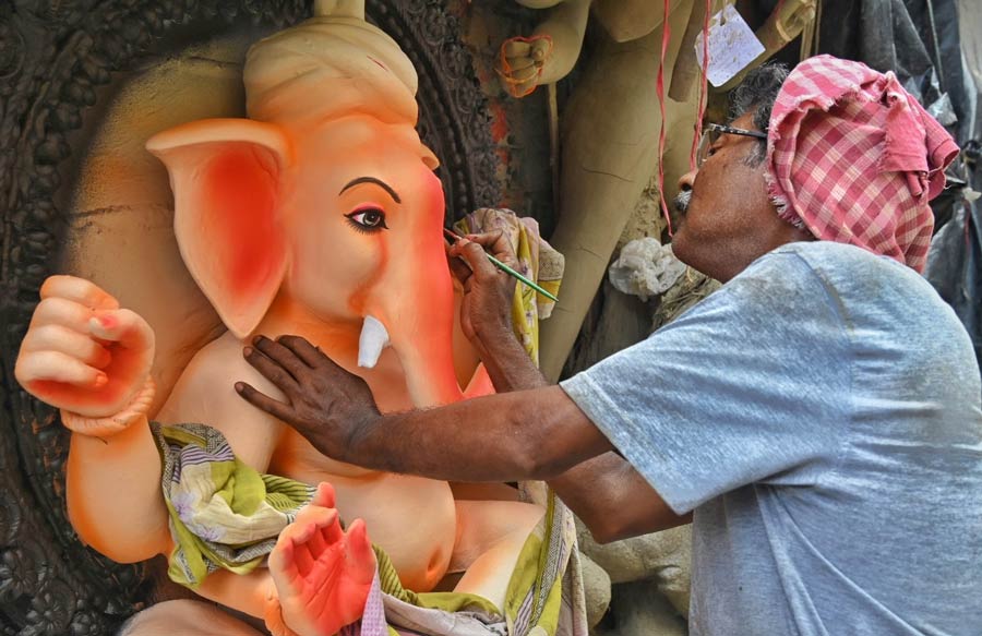 With barely a week left for the 10-day Ganesh Chaturthi to start, an artist is busy lending final touches to an idol at Kumartuli on August 31 