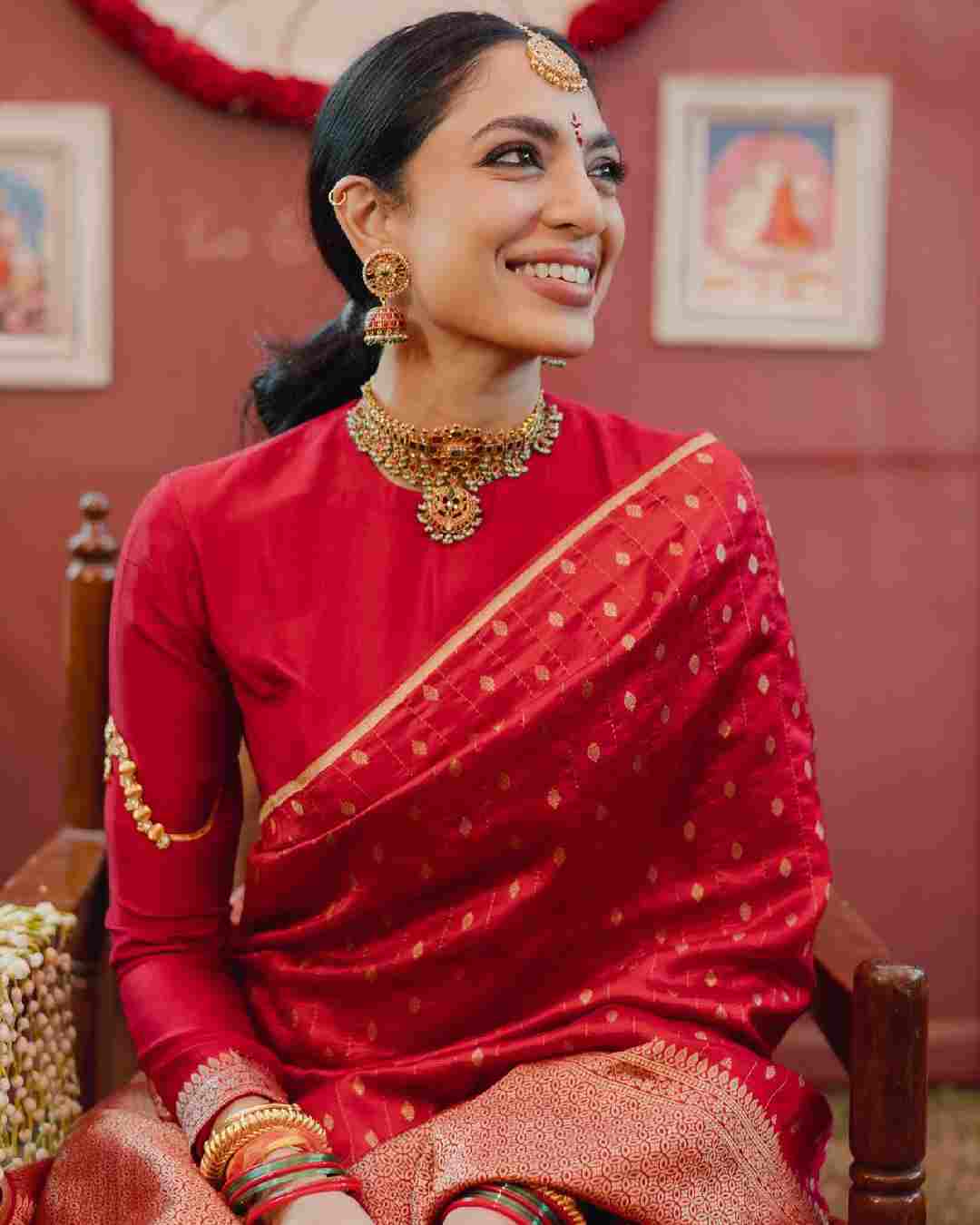 Sobhita looked gorgeous in a red sari accessorised with gold-toned jewellery.