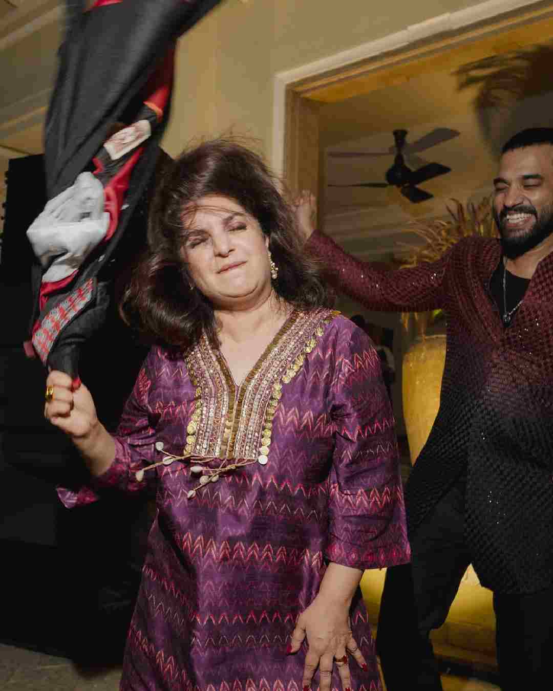 Clad in a purple suit, Farah let her hair down on the dance floor.