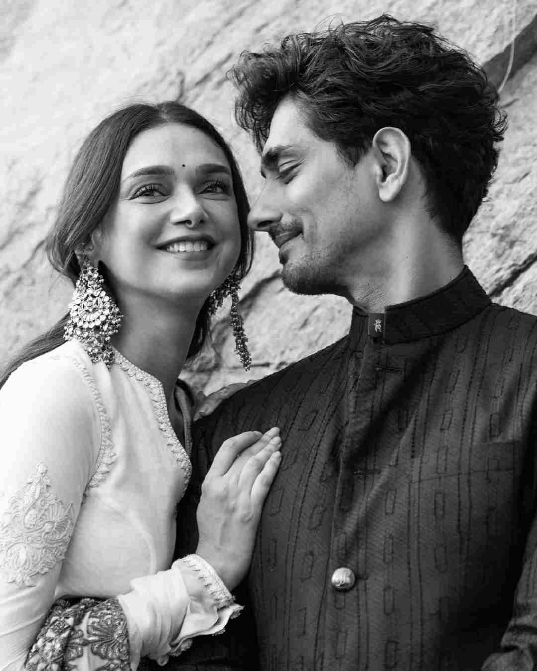A monochrome picture captures Aditi beaming with joy as Siddharth gazes at her.  