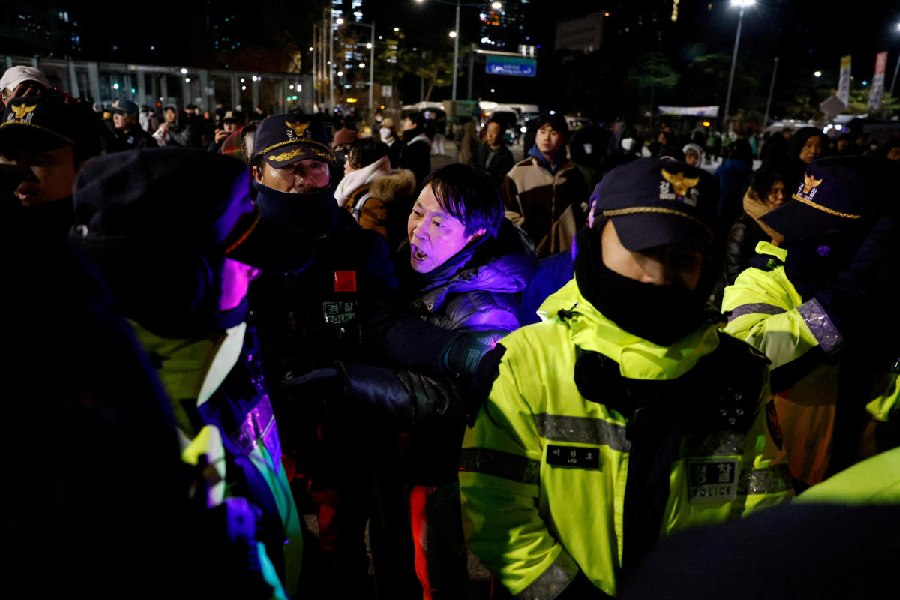 A man confronts police officers outside the National Assembly, after South Korean President Yoon Suk Yeol declared martial law, in Seoul. 