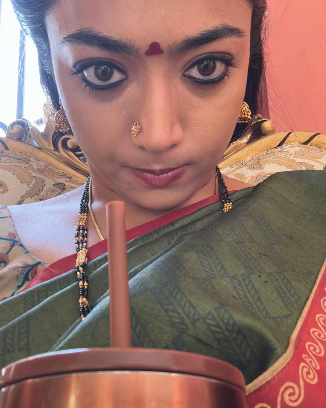 Rashmika took a goofy selfie while sipping a drink after a long filming session.
