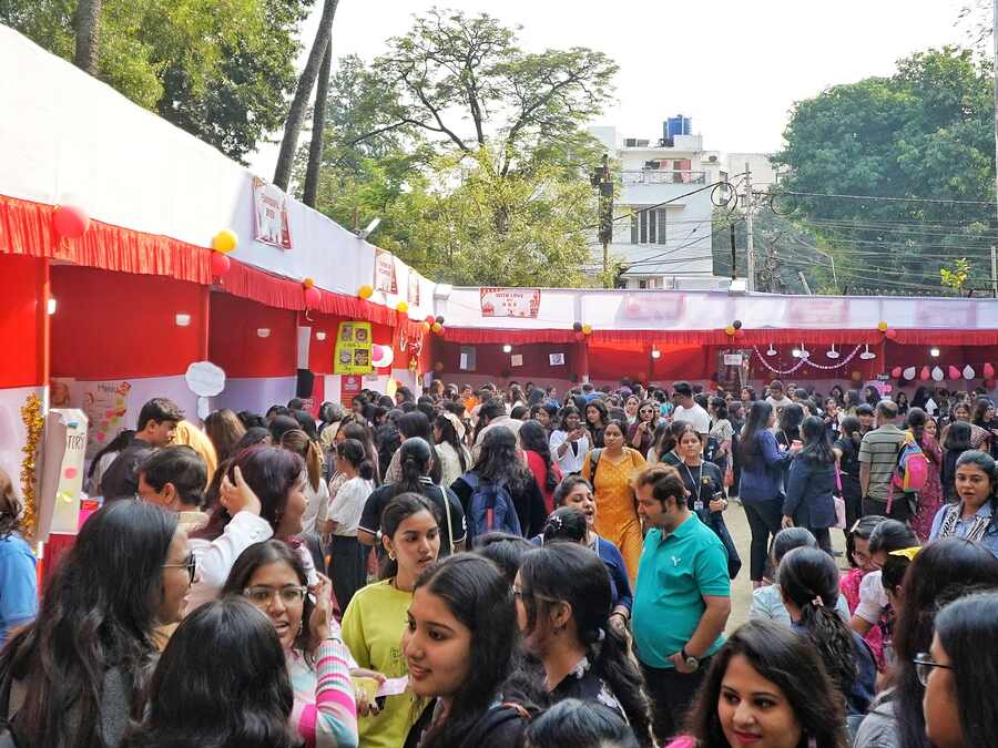 The school ground was a sea of heads all dressed up in colourful winter gear amid the red-and-white stalls 