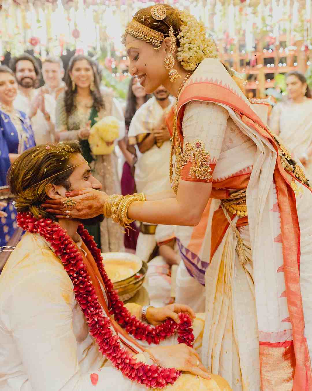 Clad in white ensembles, Sobhita smeared haldi on Chaitanya’s cheeks.  