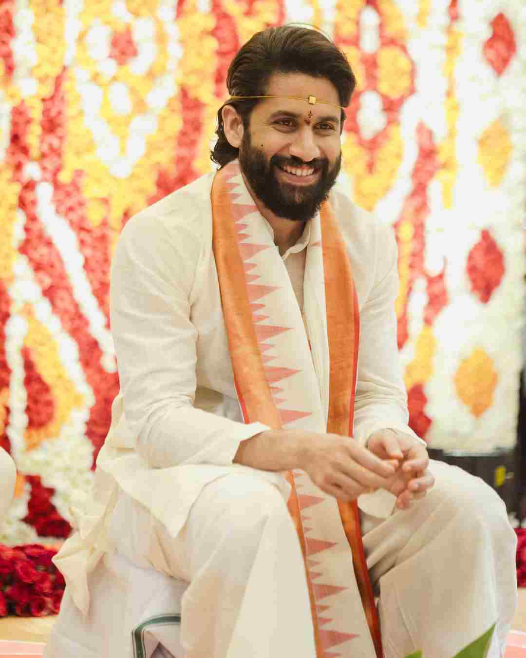 Groom Chaitanya, wrapped in an ivory ‘uparna’ with a motif matching Sobhita’s red-and-white sari, is all smiles at the ceremony.   
