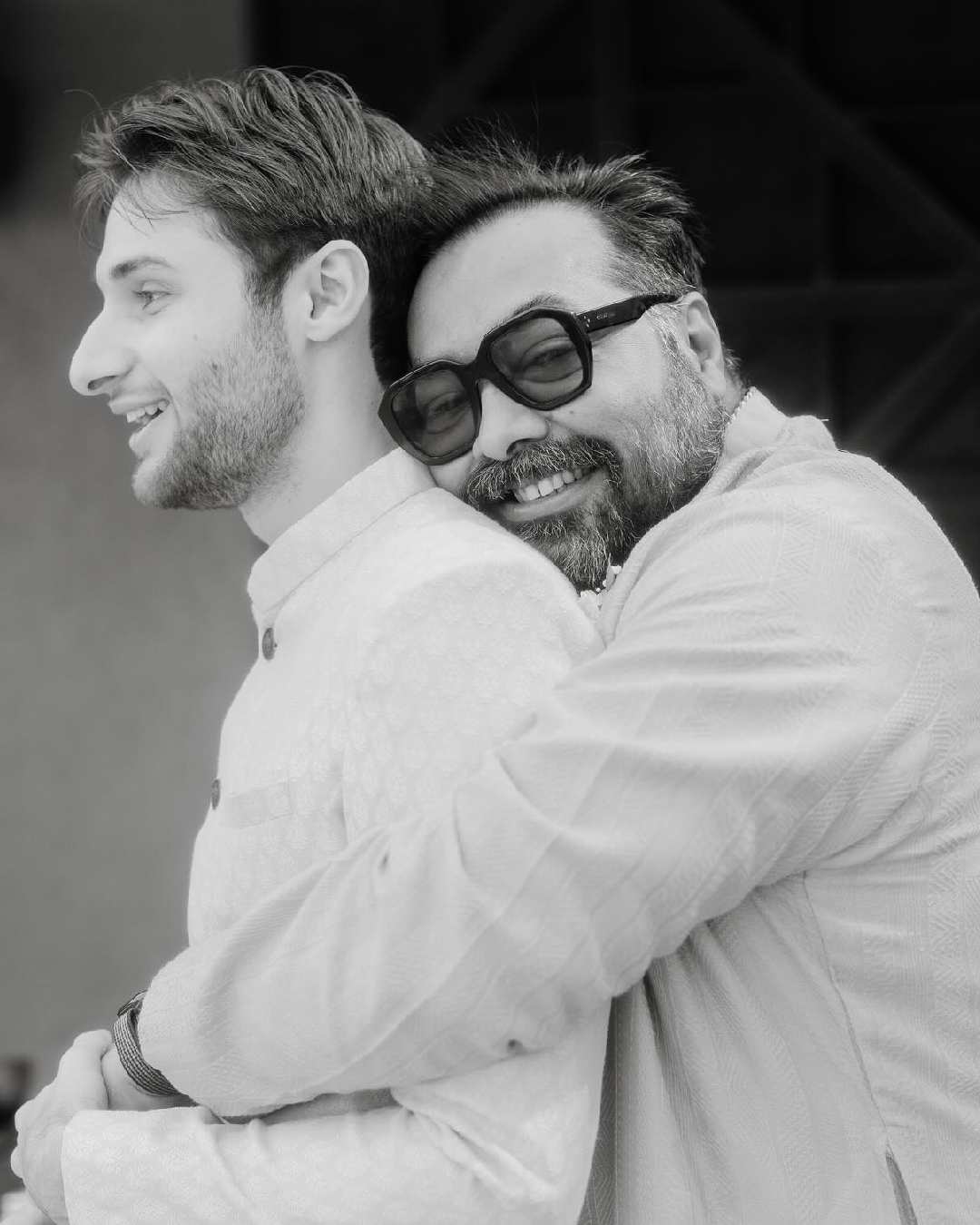 Anurag hugs his future-son-law, Shane, in a monochrome still from the ceremony.  