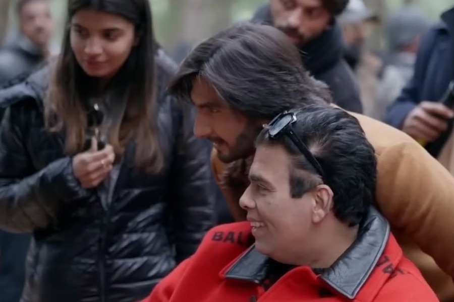 The last picture shows Karan sporting a red Balenciaga blazer and smiling in between shots for Rocky Aur Rani Kii Prem Kahaani. Ranveer Singh also features in the photo.