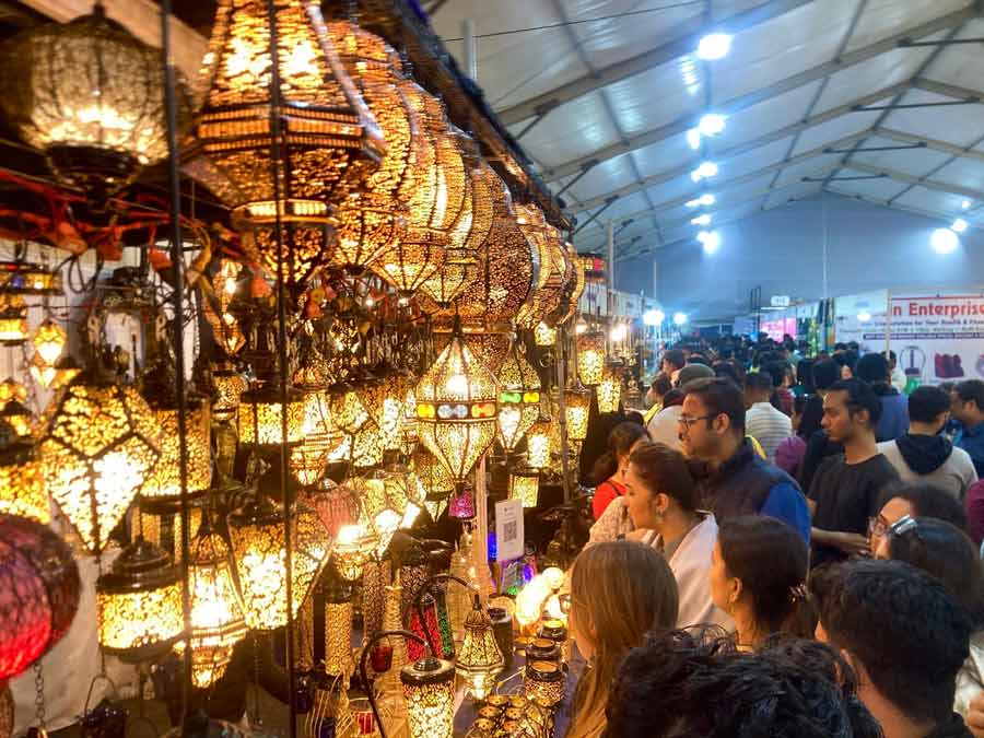As the India International Grand Trade Fair continues, people buy decorative lampshades on Tuesday. The fair will continue till December 15