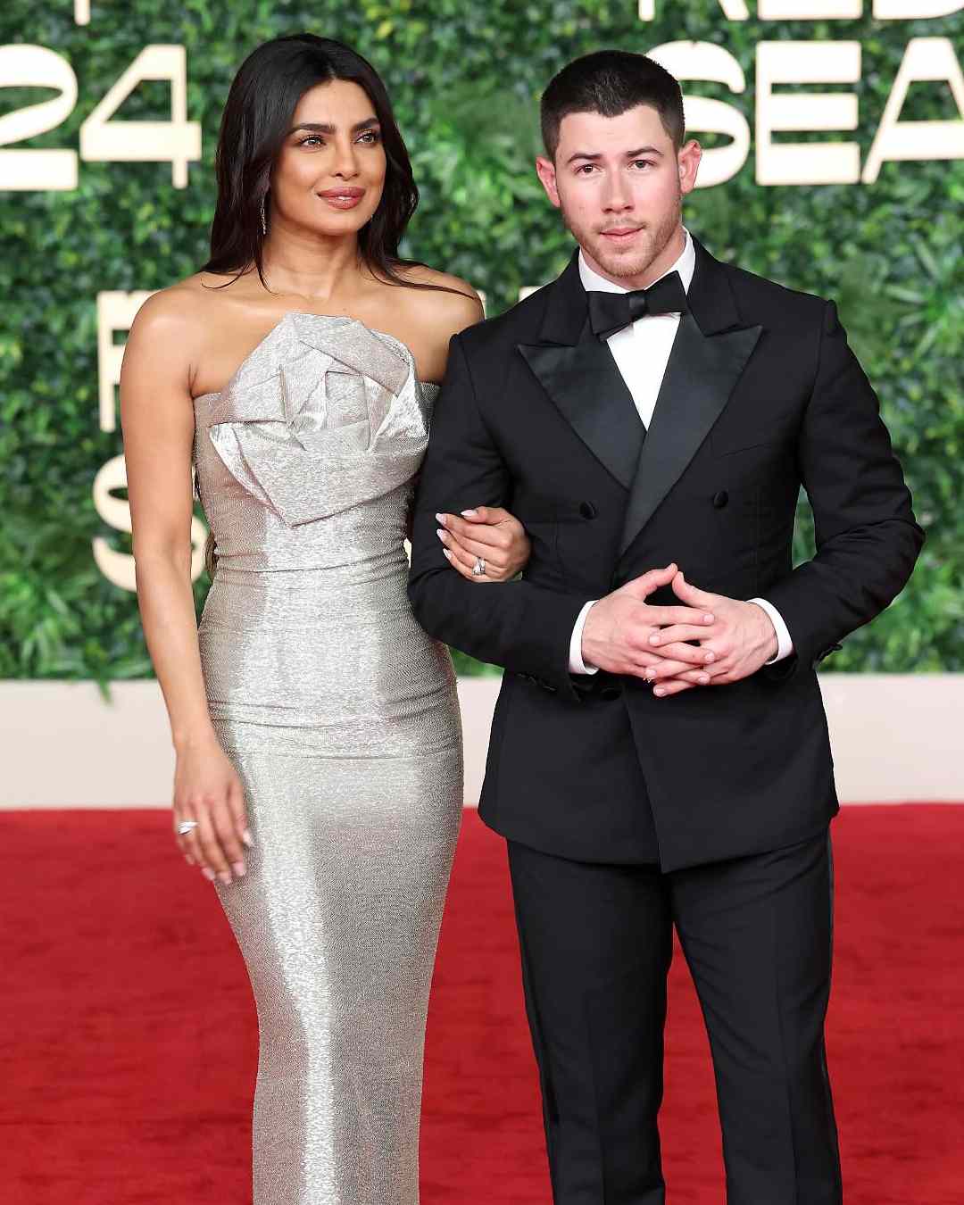 Nick Jonas’s crisp black suit perfectly complemented his wife’s metallic ensemble. 