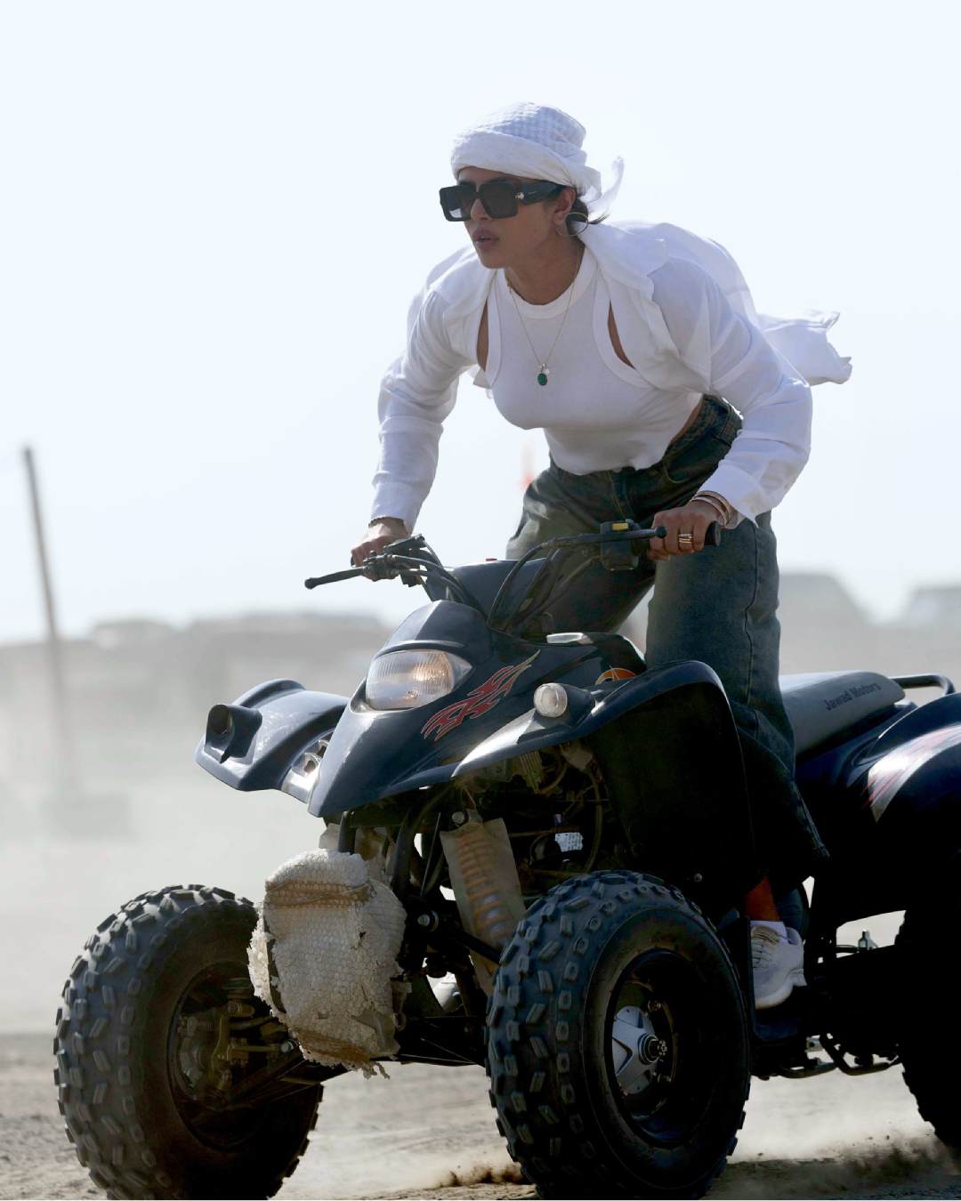 Priyanka Chopra riding an ATV in a desert in Jeddah, Saudi Arabia