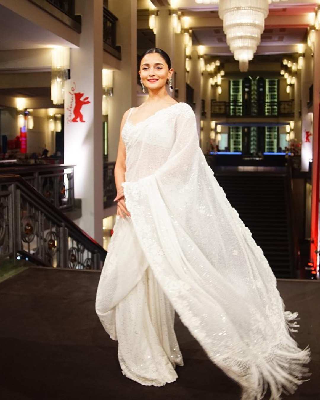 Alia Bhatt’s shimmery white sari draped over a sleeveless blouse made for a perfect evening look. 