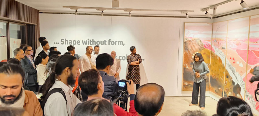 Mukulita Ganguly, a multidisciplinary movement artist from Kolkata, puts up a contemporary dance performance. Behind her is ‘Mauna Mukharata’ by artist Suman Chandra, on display at the exhibition Shape Without Form, Shade Without Colour