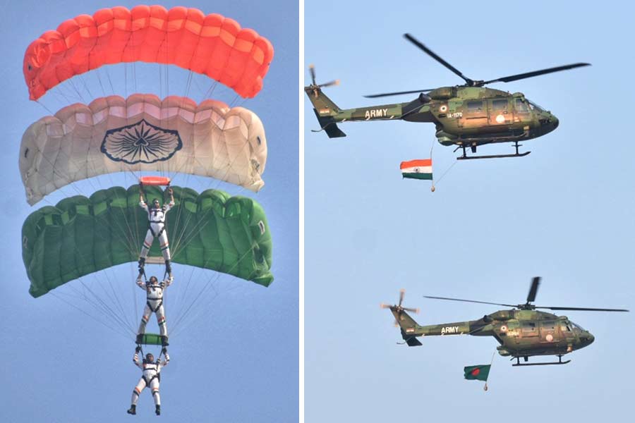 A Tricolour parachute with three soldiers and helicopters adorned with the Indian and Bangladeshi flags at the show 