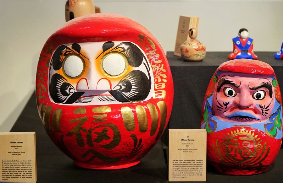 The eyecatching dolls are displayed with a brief note about their history. In the collection is the popular Takasaki Daruma, a paper doll made by artist Minegishi Kimitsugu. The history of the doll speaks about Daruma Daishi, which is the Japanese name given to Bodhidharma, who, legend says, was the founder of Zen Buddhism. The dolls are used to manifest wishes and the eyes are not painted when they are made because one eye is drawn while making a wish, and the second eye is drawn on the fulfillment of the wish