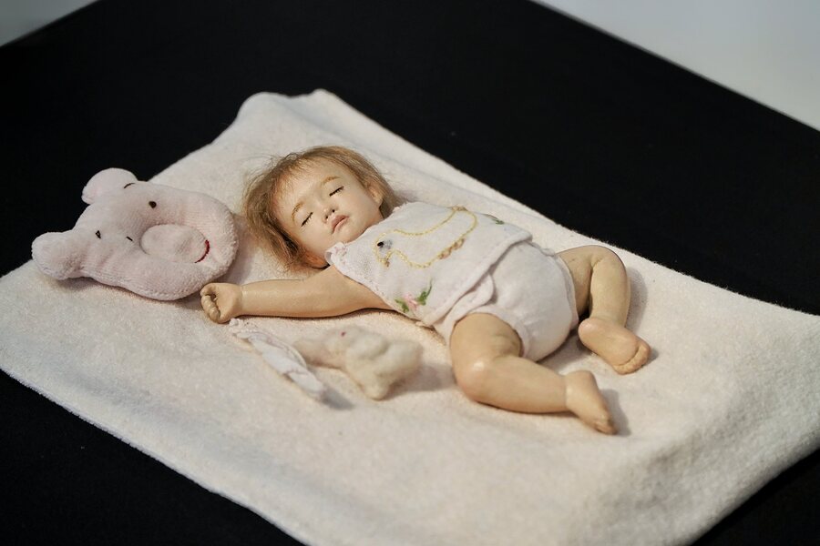 Titled ‘Peacefully’, this doll of a child with an angelic face sleeping peacefully is known for its human-like skin, which is made of leather